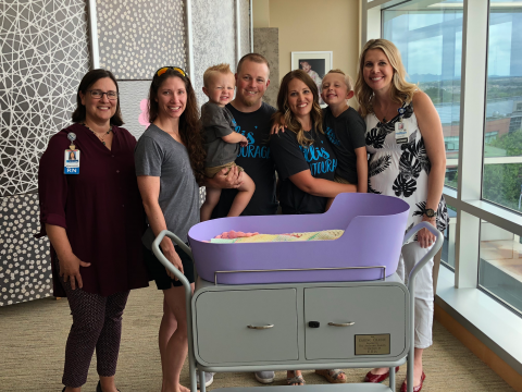 Methodist Employees posing with Caring Cradle device