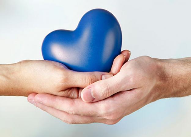 Two hands holding a blue heart